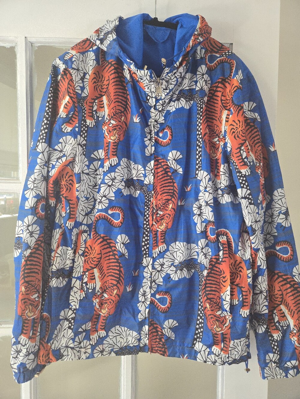 Gucci Blue Hooded Jacket with Orange Tiger Motif.